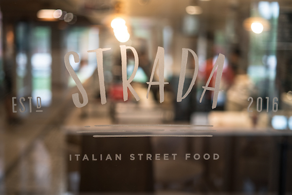 Strada logo on glass door