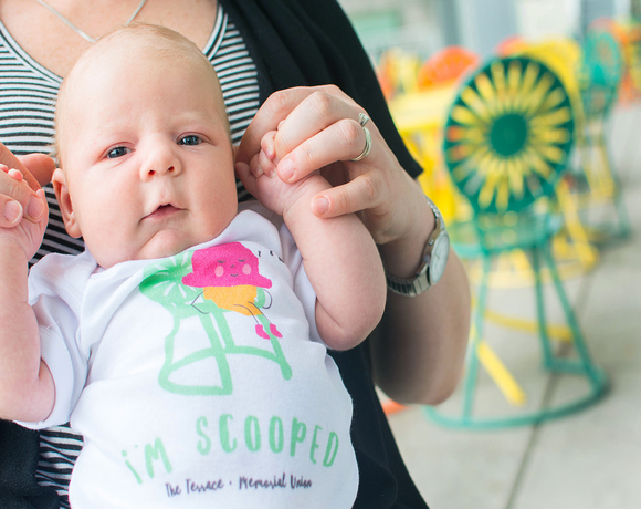 Baby in a onesie from the Terrace Store