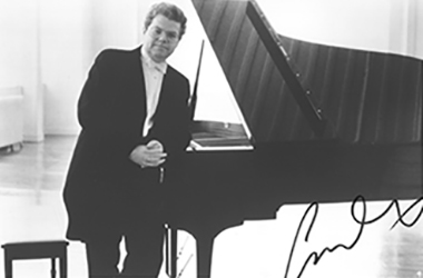 Signed photo of Emanuel Ax next to piano