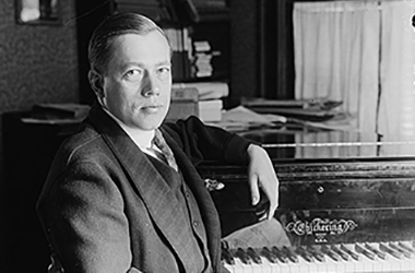 Reinald Werrenrath next to a piano