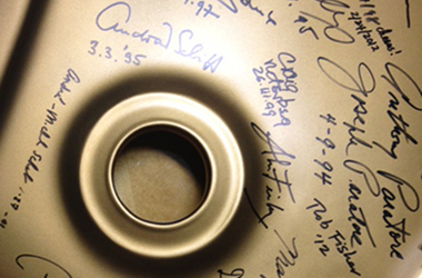 Close-up of signatures on a grand piano, including that of André-Michel Schub
