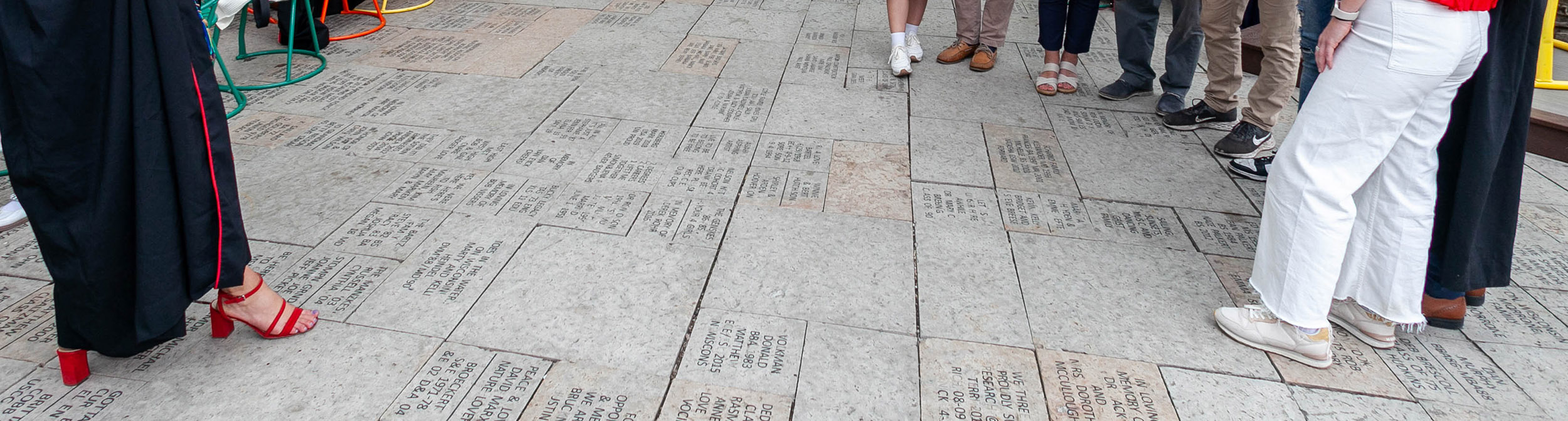 Graduates gather for a photo, standing on the Terrace pavers