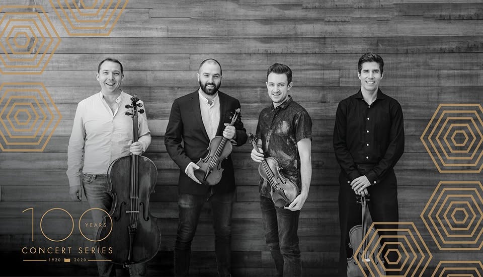 Black and white photo of the Escher String Quartet holding their instruments.