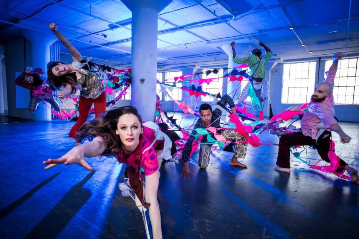 Dancers in vibrant outfits in motion.