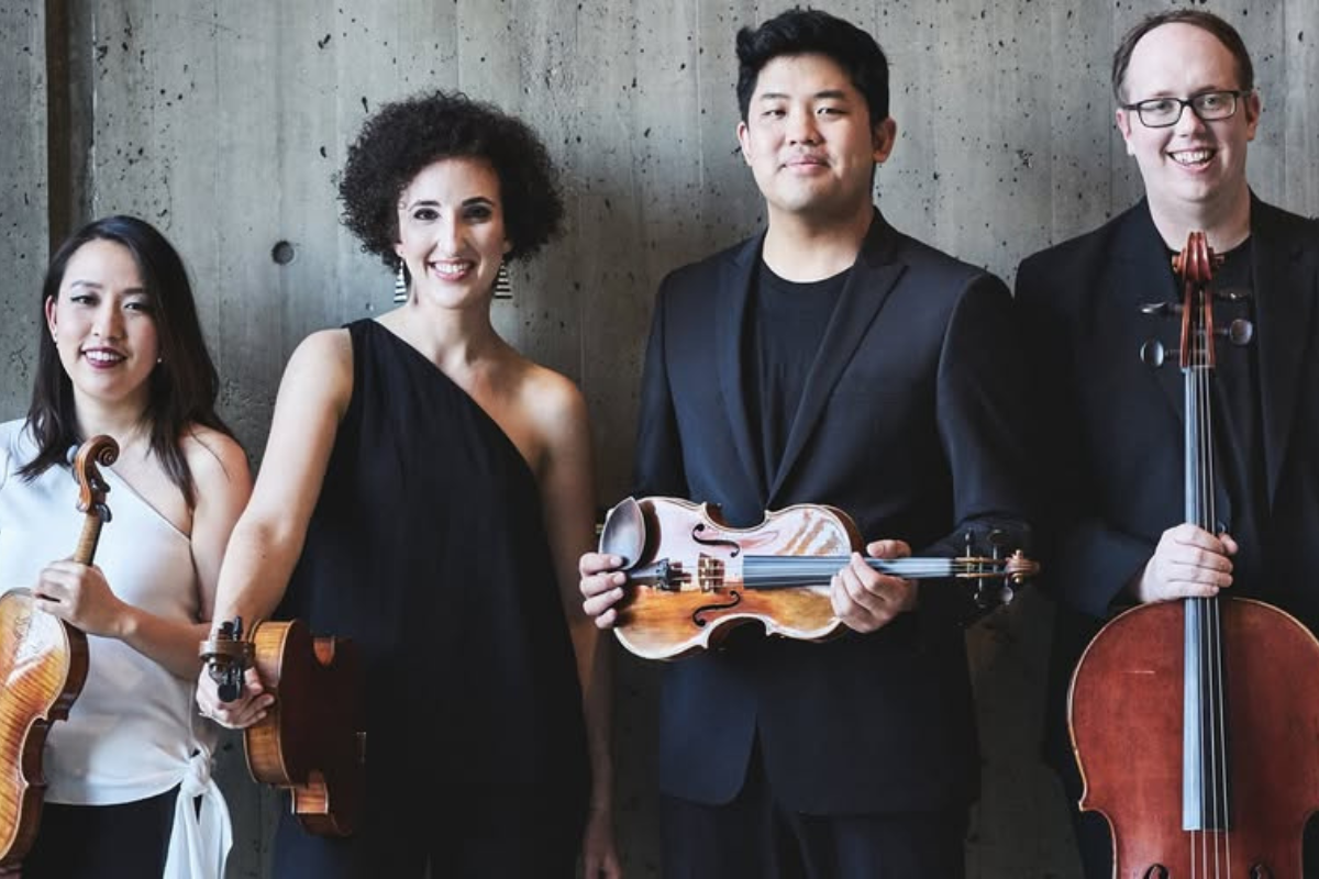Verona Quartet standing, holding their instruments.