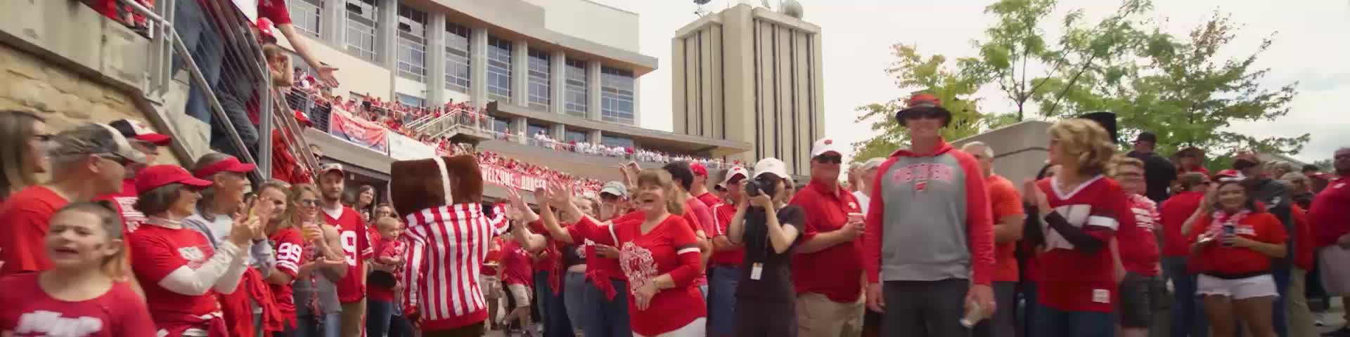 Bucky Badger makes his way through a red-clad crowd at Badger Bash