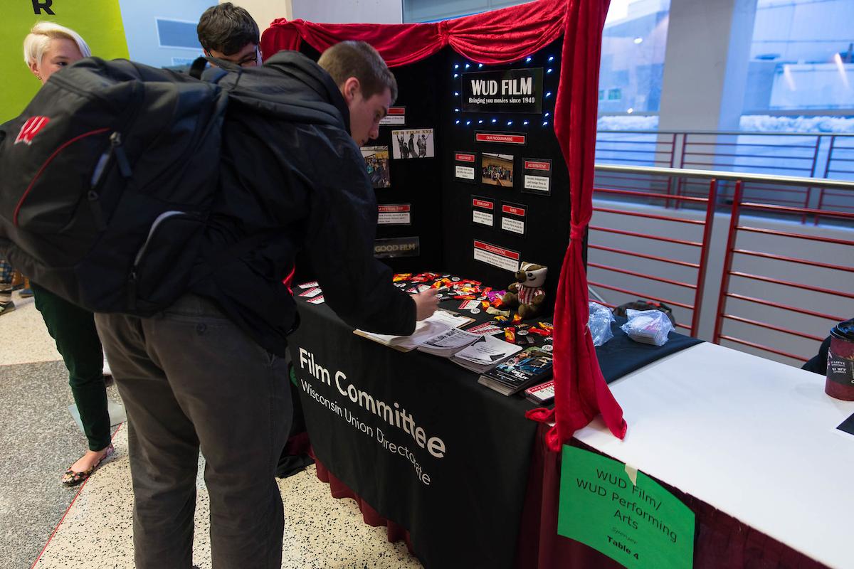 A student signs up at a WUD Film table display at the Student Organization fair.