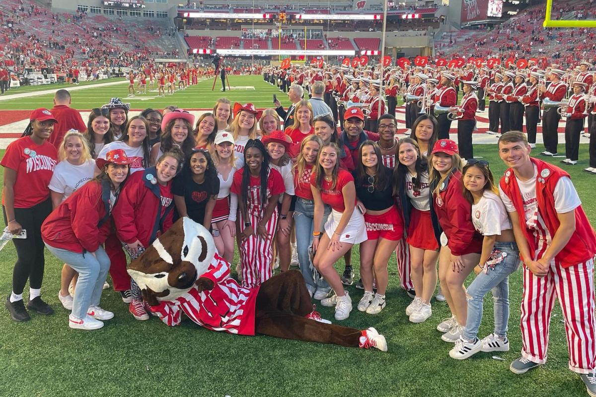 Homecoming Committee group photo with Bucky on Camp Randall field