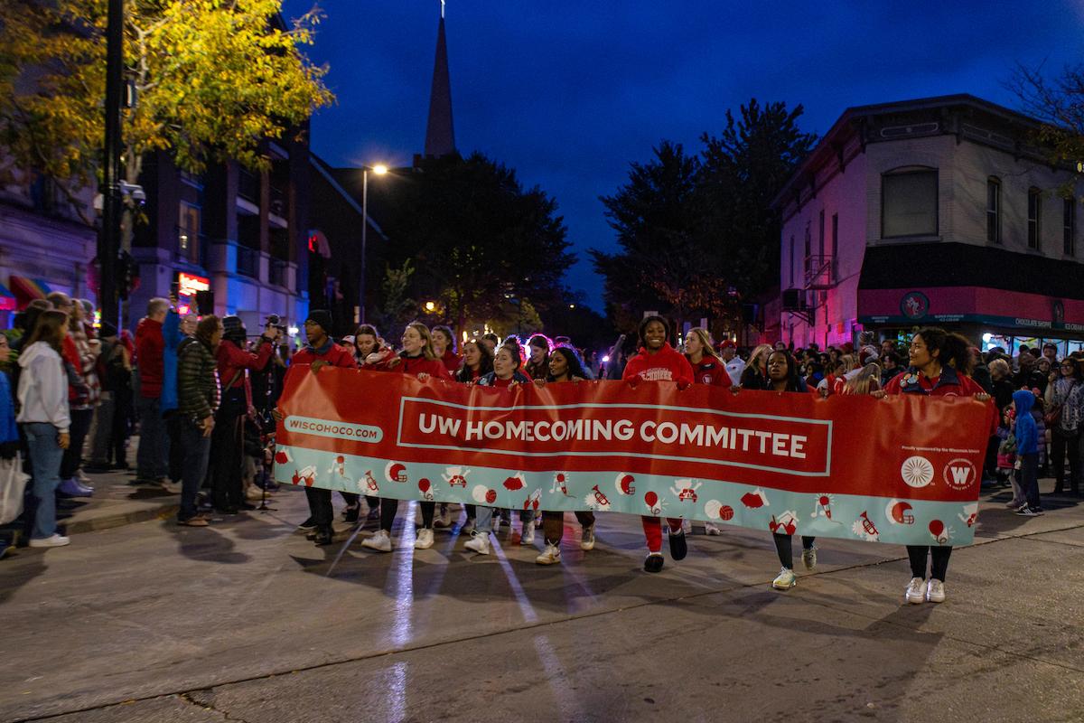 Homecoming Committee banner being carried during the UW Homecoming Parade