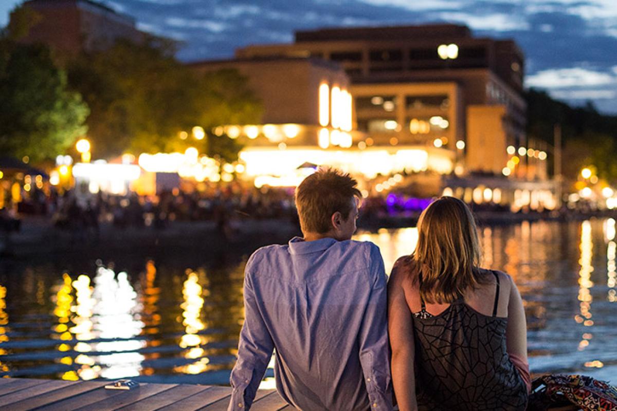 Two Union members sit on a pier near the Terrace in the eveing