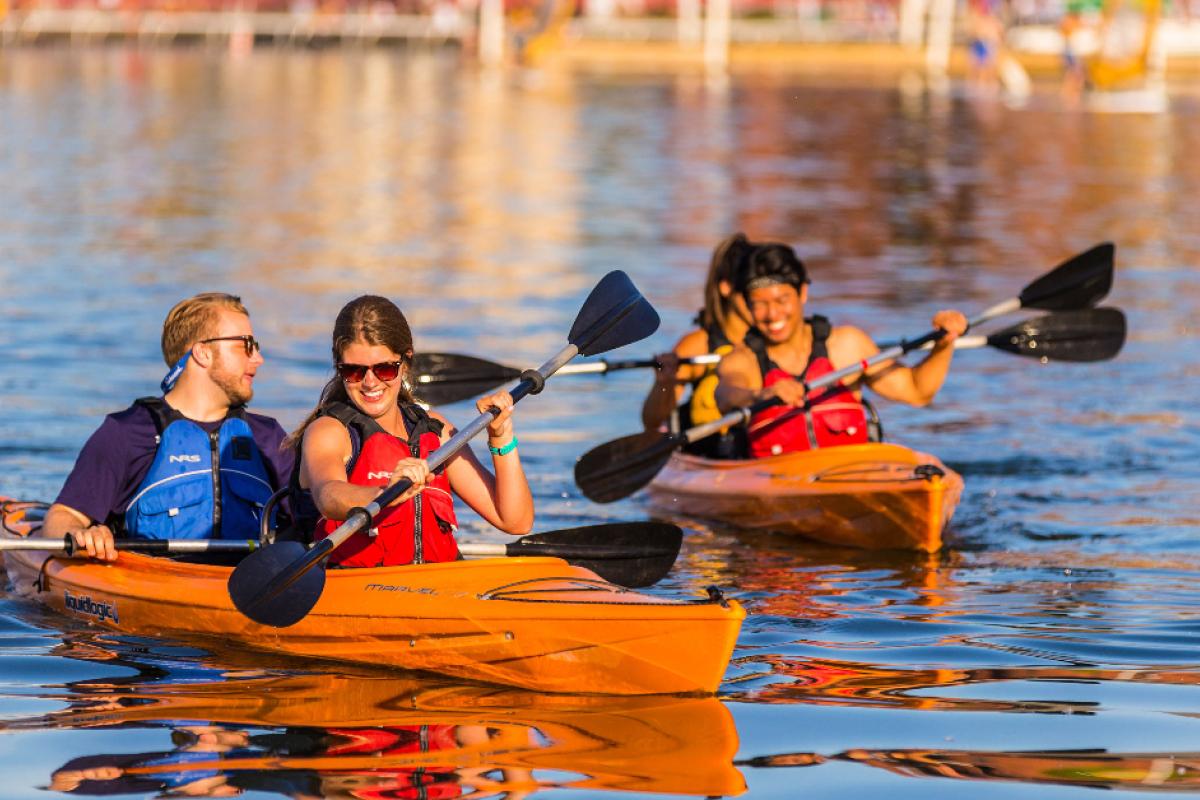 People navigating the lake in two paddleboats