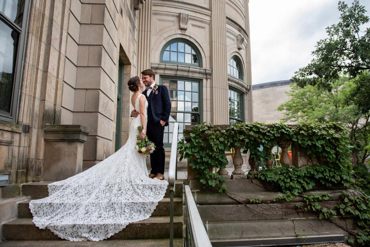 Bride and groom on steps leading up to Memorial Union
