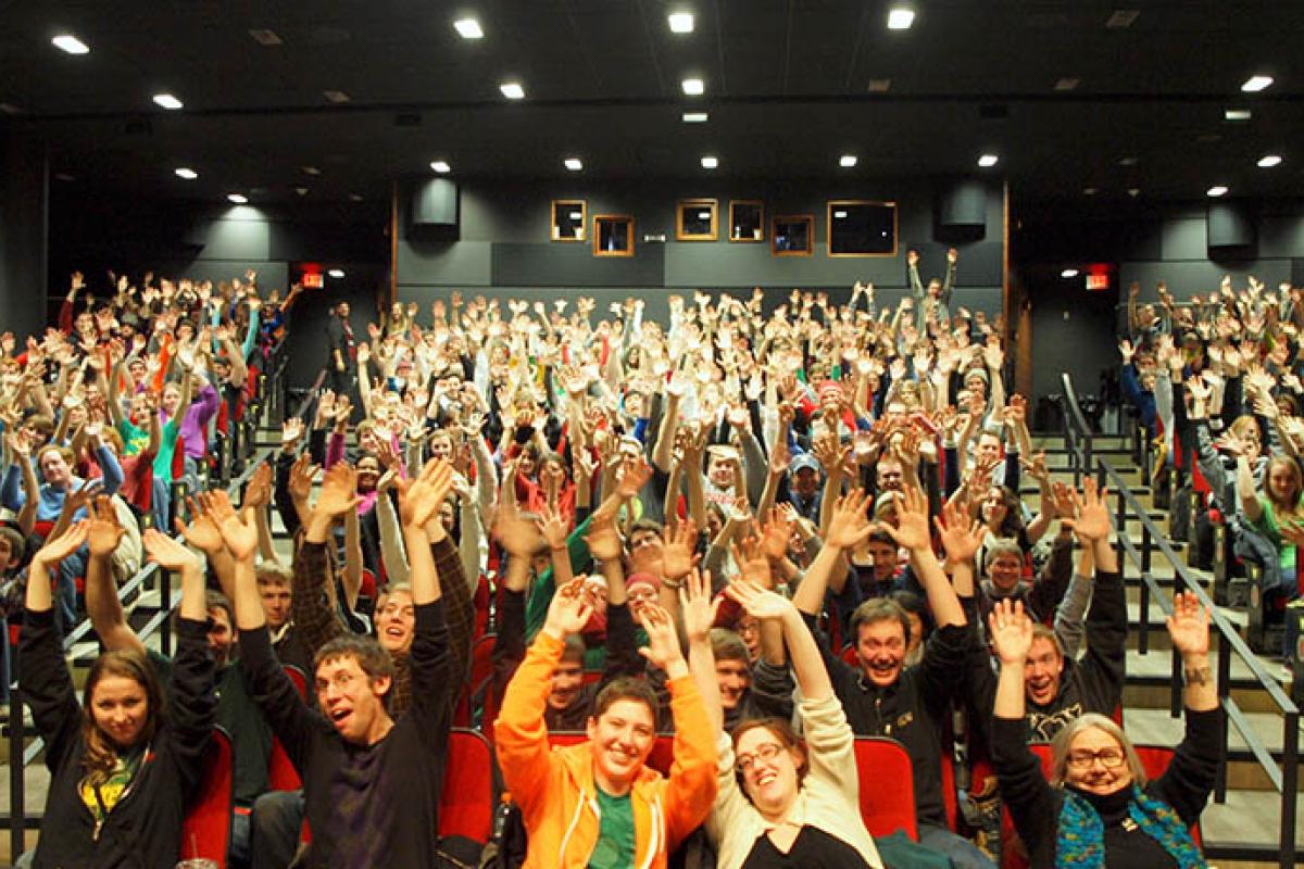A sold-out crowd at the Marquee Theater raises their hands in unison