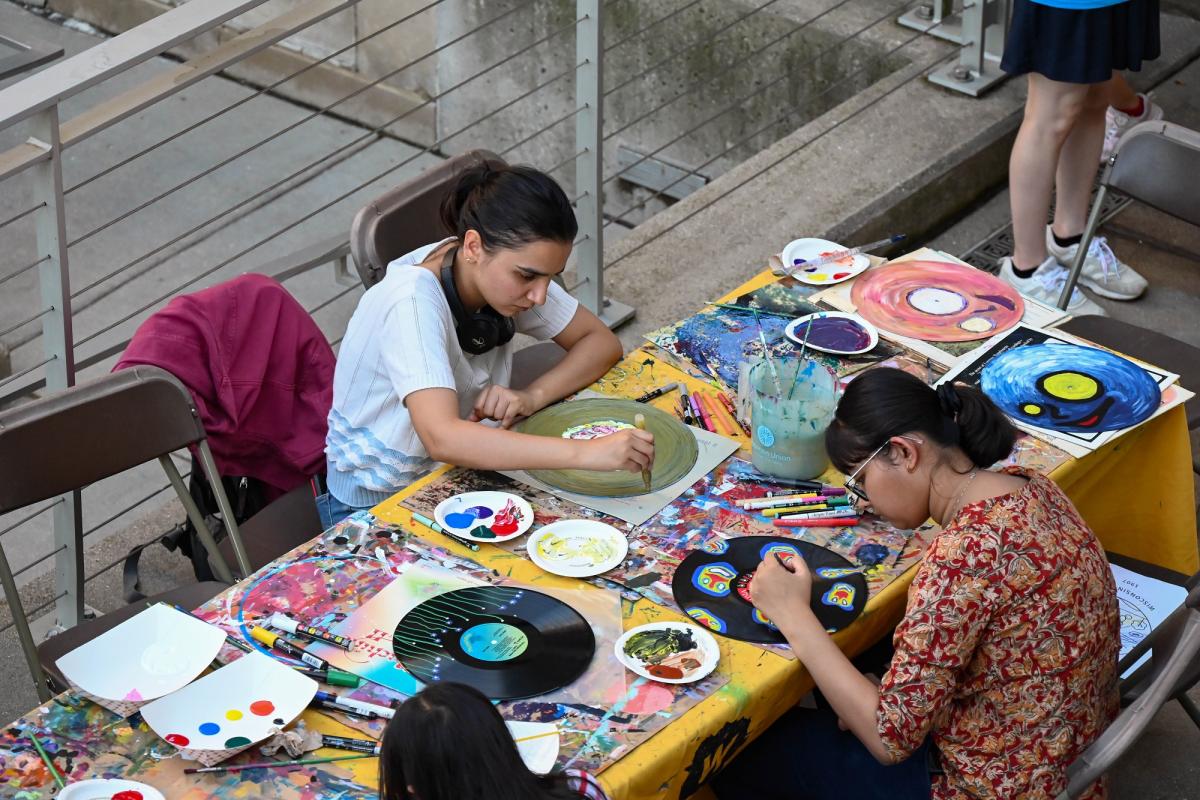 Participants painting vinyl records at Terrace Art Zone
