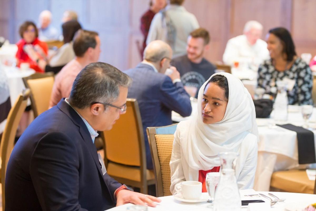 Two WUA members talking at a table during a spring luncheon