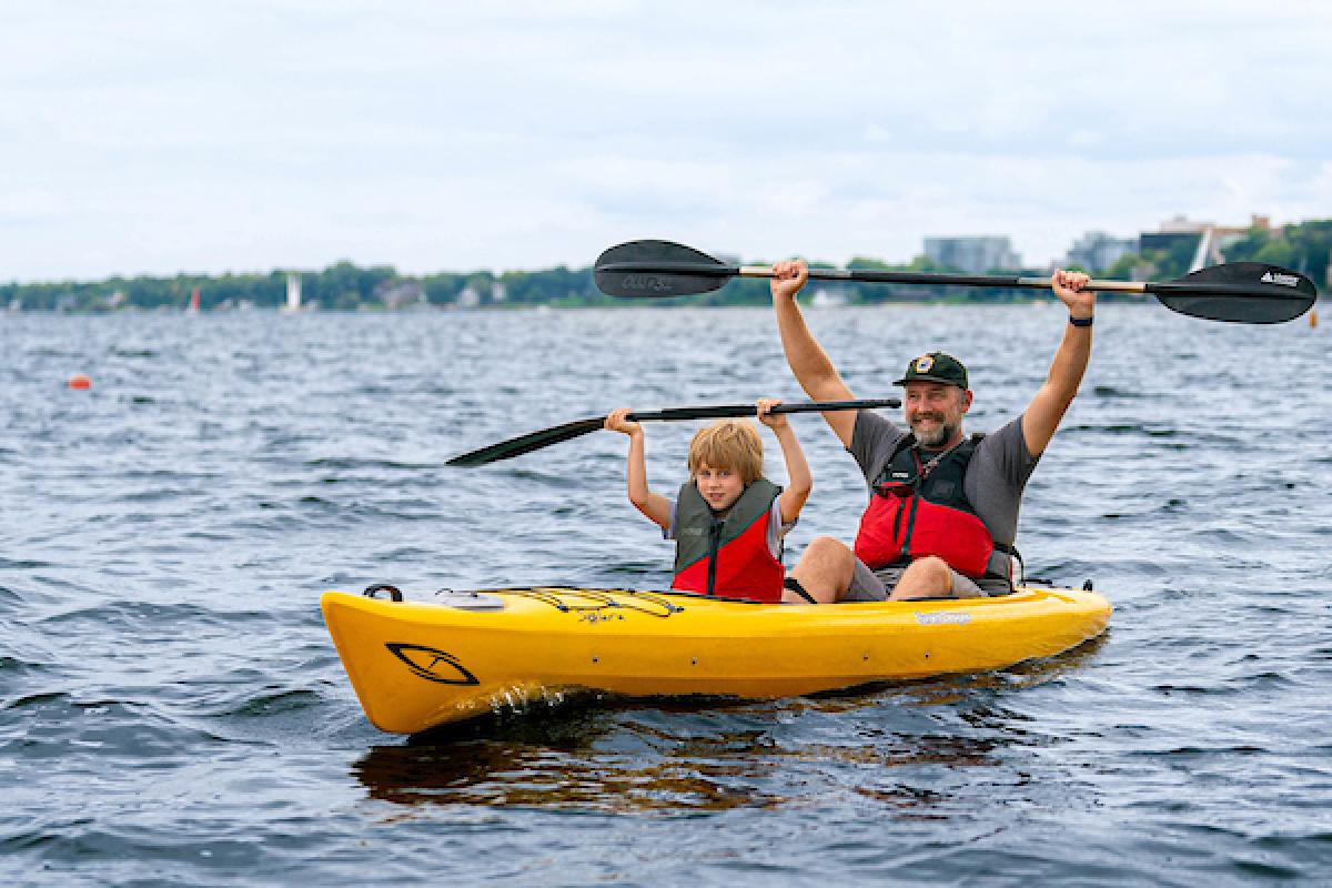 Father and son paddling a kayak