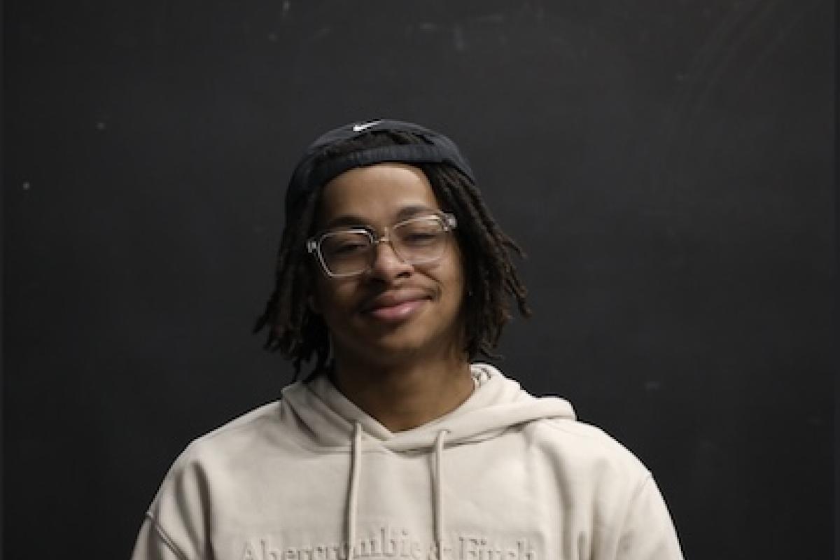 Portrait of Jordan Waters in tan sweatshirt