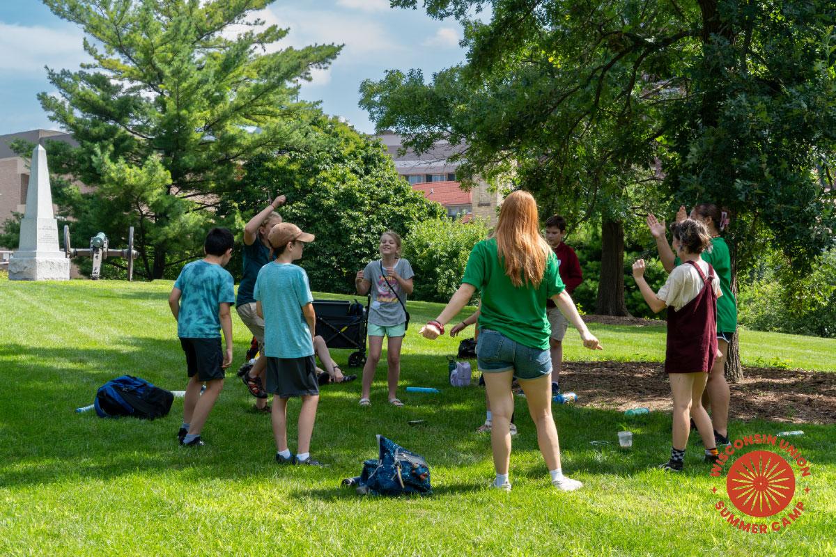 group of children standing in a circle playing a game.
