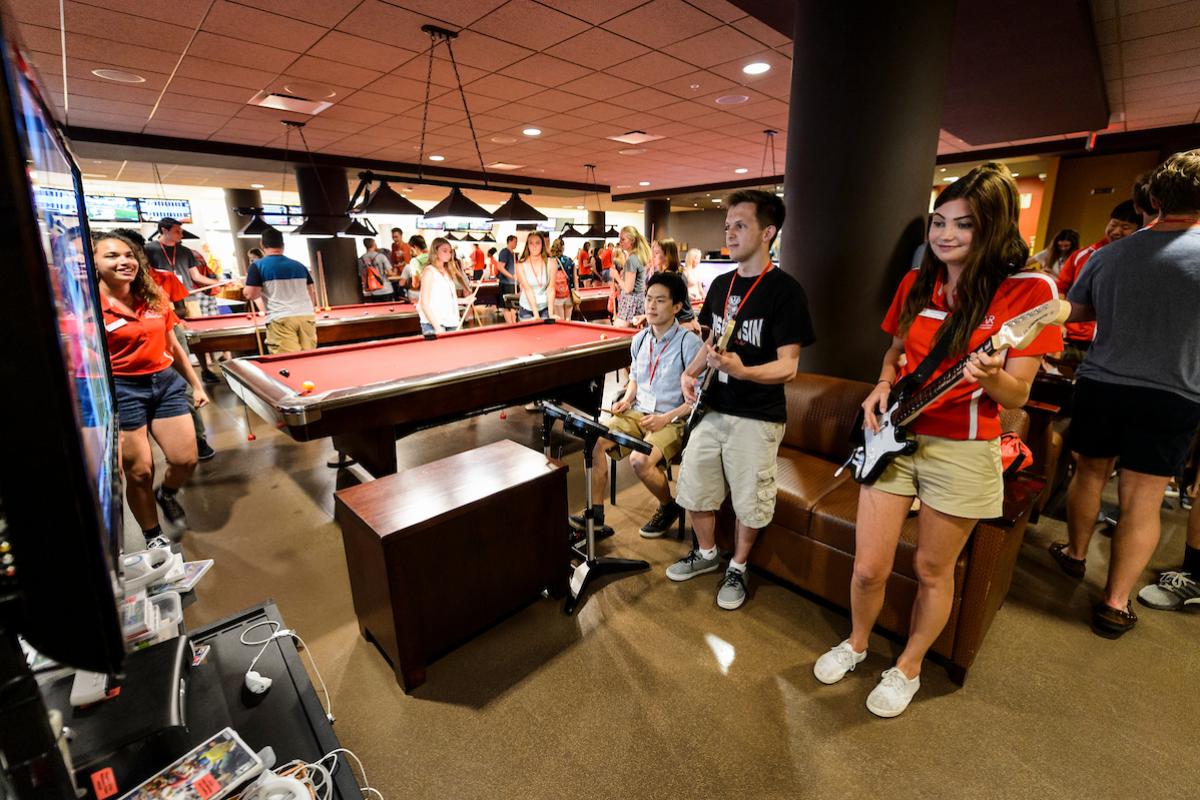 Students playing guitar hero, and pool at Union South Sett Recreation.