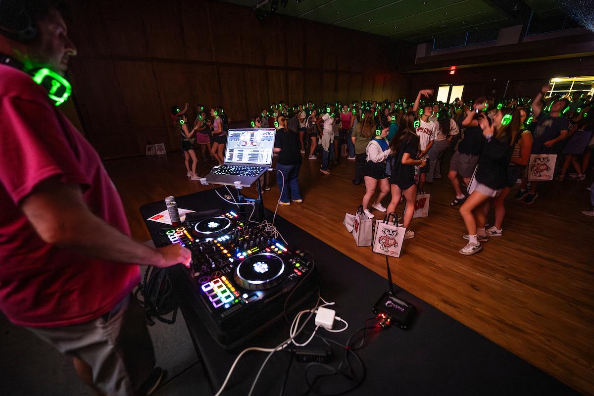 Students dancing at a silent disco with headphones on.