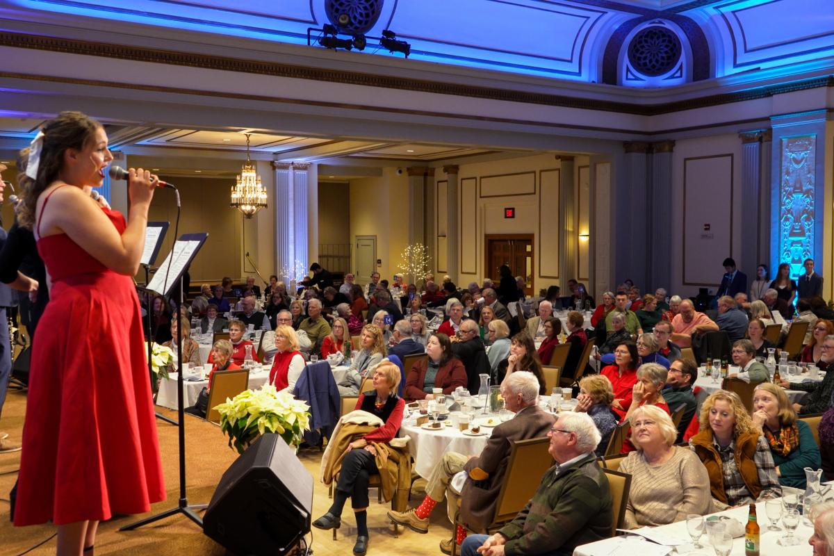 Wisconsin Singers signing to a crowd of people listening