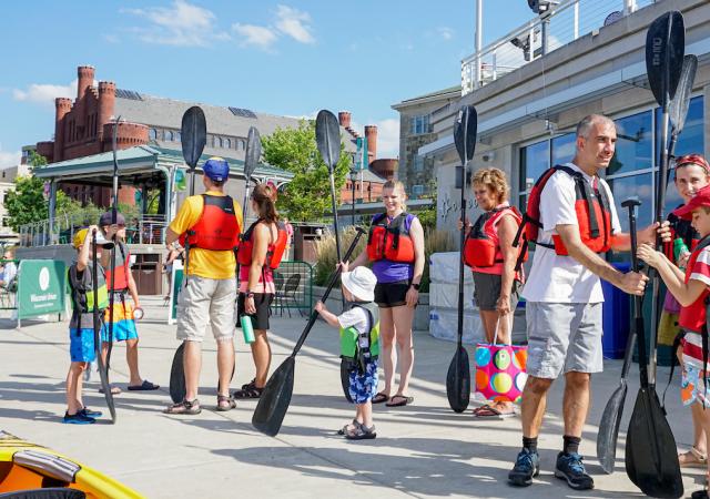 Families preparing to paddle on the lake
