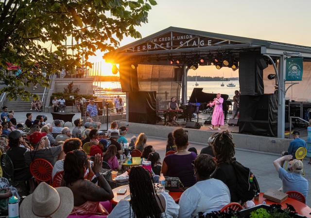 Individual performing music in front of a crowd on the Terrace