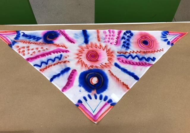 Bandana dyed with blue, orange, and pink coloring.