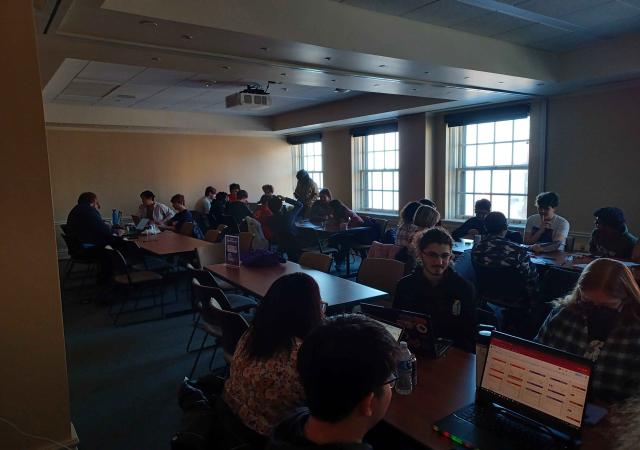 Many people playing roleplaying games around tables