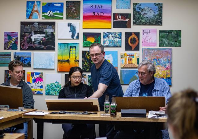 Art instructor with students at Wheelhouse Studios