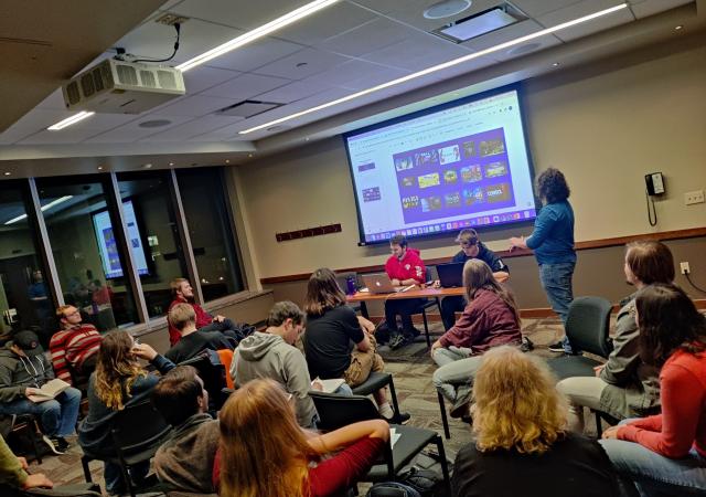 A group of people looking at a screen