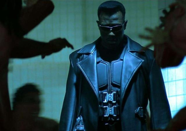 Image from film Blade. Man in supersuit stands in shadows.