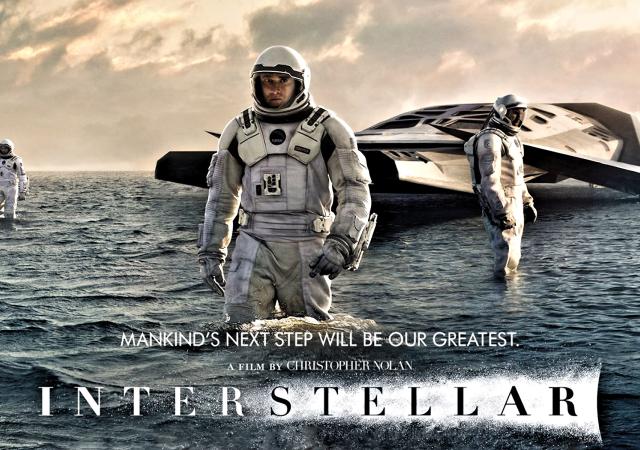 Still from film Interstellar, man in space suit stands in water.