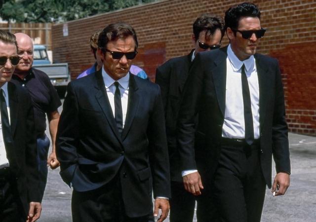 Still from film Reservoir Dogs, men in suits walking.