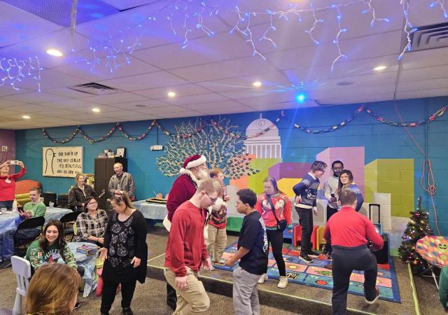 GiGi's Holiday party participants and volunteers interacting at and enjoying the party