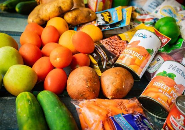 produce and canned goods on a table surface