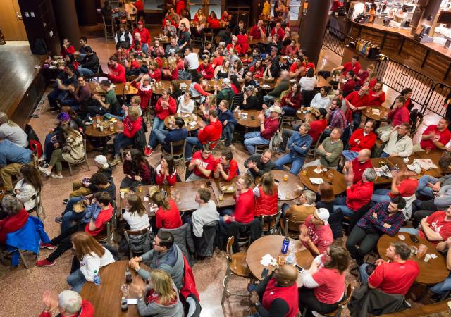 Individuals watching a sports game in the Sett