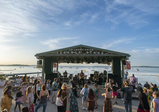 Photo of the memorial union terrace stage with people dancing.