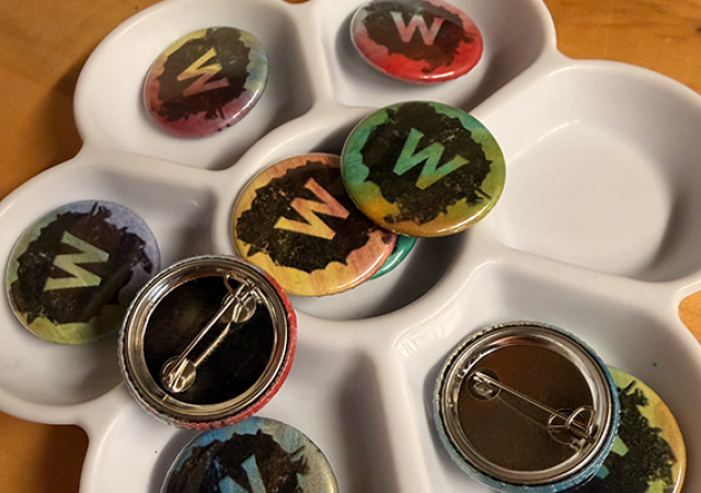 Photo of a collection of buttons with the Wheelhouse Studios logo.