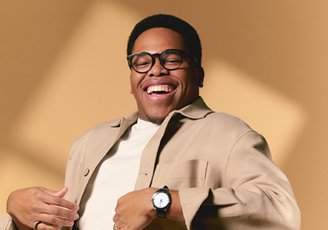 Photo of Isaiah J. Thompson sitting in front of a tan background.