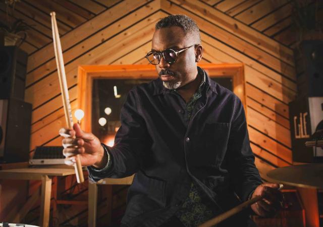 Photo of Nate Smith holding a drum stick.
