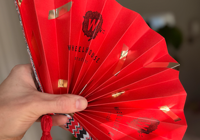 Photo of a crafted red folding fan.