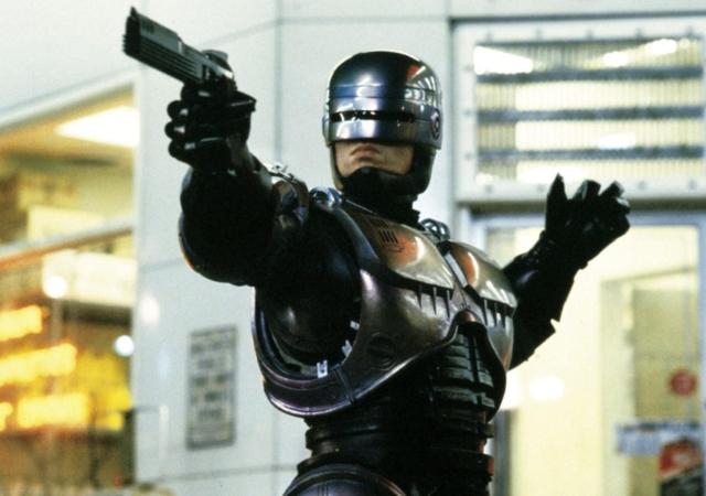 cyborg holding up a weapon