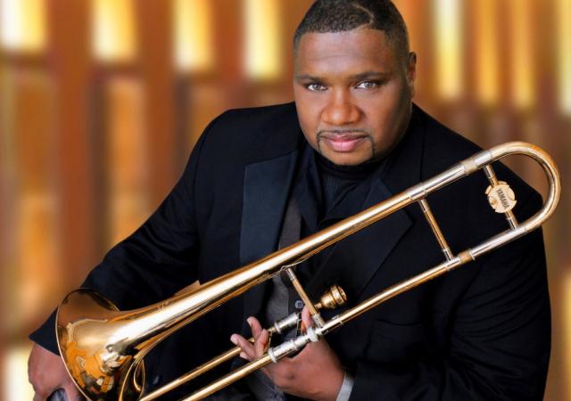 Wycliffe Gordon holding a trombone.