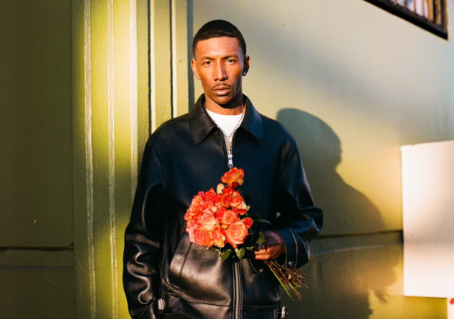 blAck pARty holding a bouquet of flowers against a sunlit background.