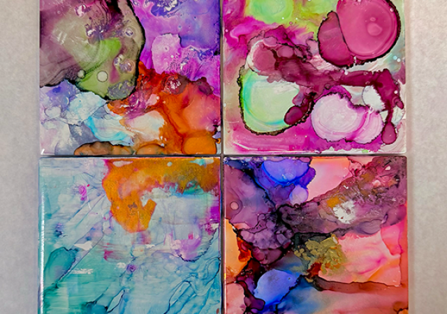 Photo of four different colored paintings.