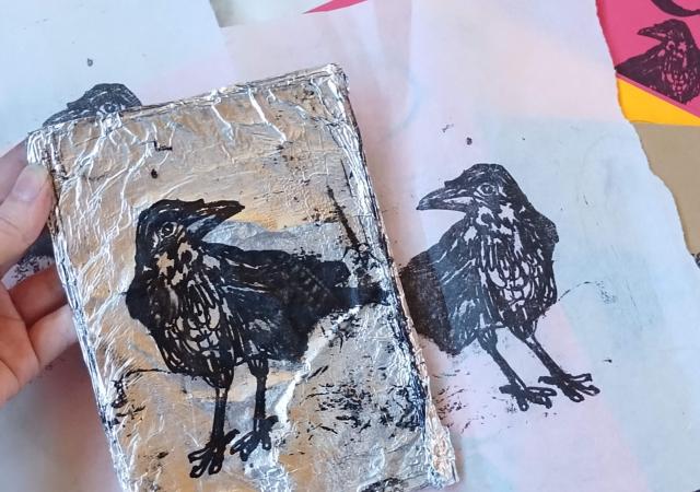 Photo of an art project using tin foil and prints.