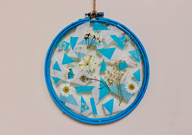 Photo of a suncatcher with pressed flowers inside.