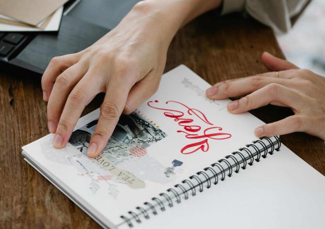 Photo of someone working in a journal notebook.