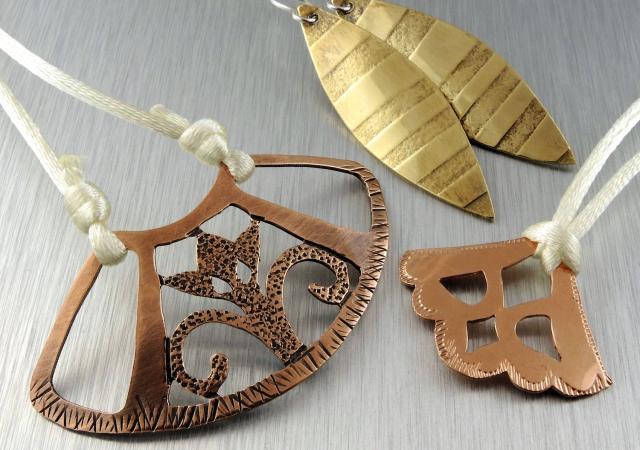 Photo of three different pieces of jewelry made from metal.